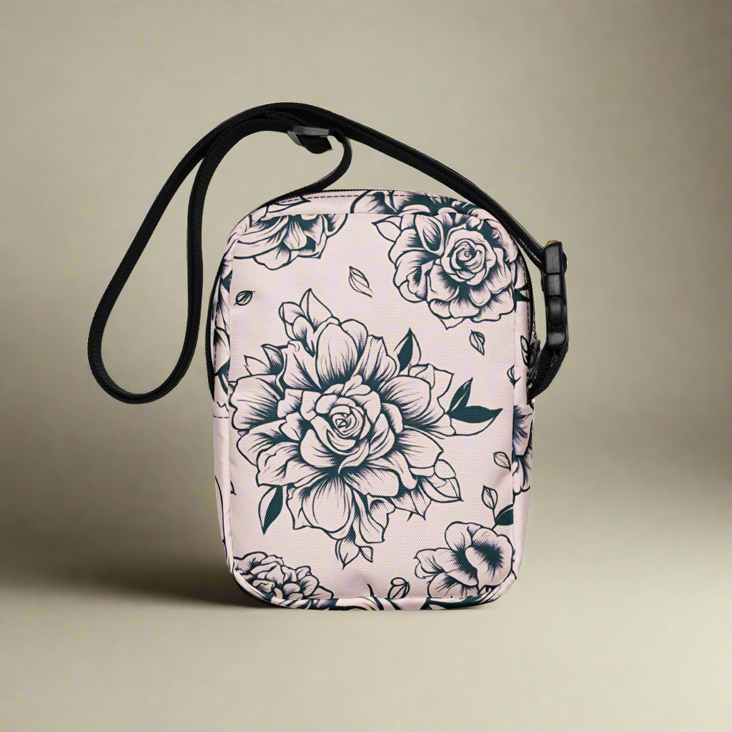 Compact and functional tattoo rose crossbody bag in pink, designed for daily errands, concerts, festivals, or travel. Made from sturdy polyester with fusible backing for structure, this small floral crossbody purse features an adjustable strap, inside and outside pockets, and durable two-way zipper. A stylish women’s shoulder bag with bold rose tattoo print, perfect for organizing essentials while on the go.