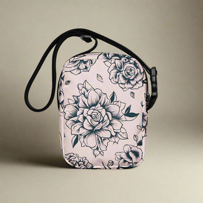 Compact and functional tattoo rose crossbody bag in pink, designed for daily errands, concerts, festivals, or travel. Made from sturdy polyester with fusible backing for structure, this small floral crossbody purse features an adjustable strap, inside and outside pockets, and durable two-way zipper. A stylish women’s shoulder bag with bold rose tattoo print, perfect for organizing essentials while on the go.