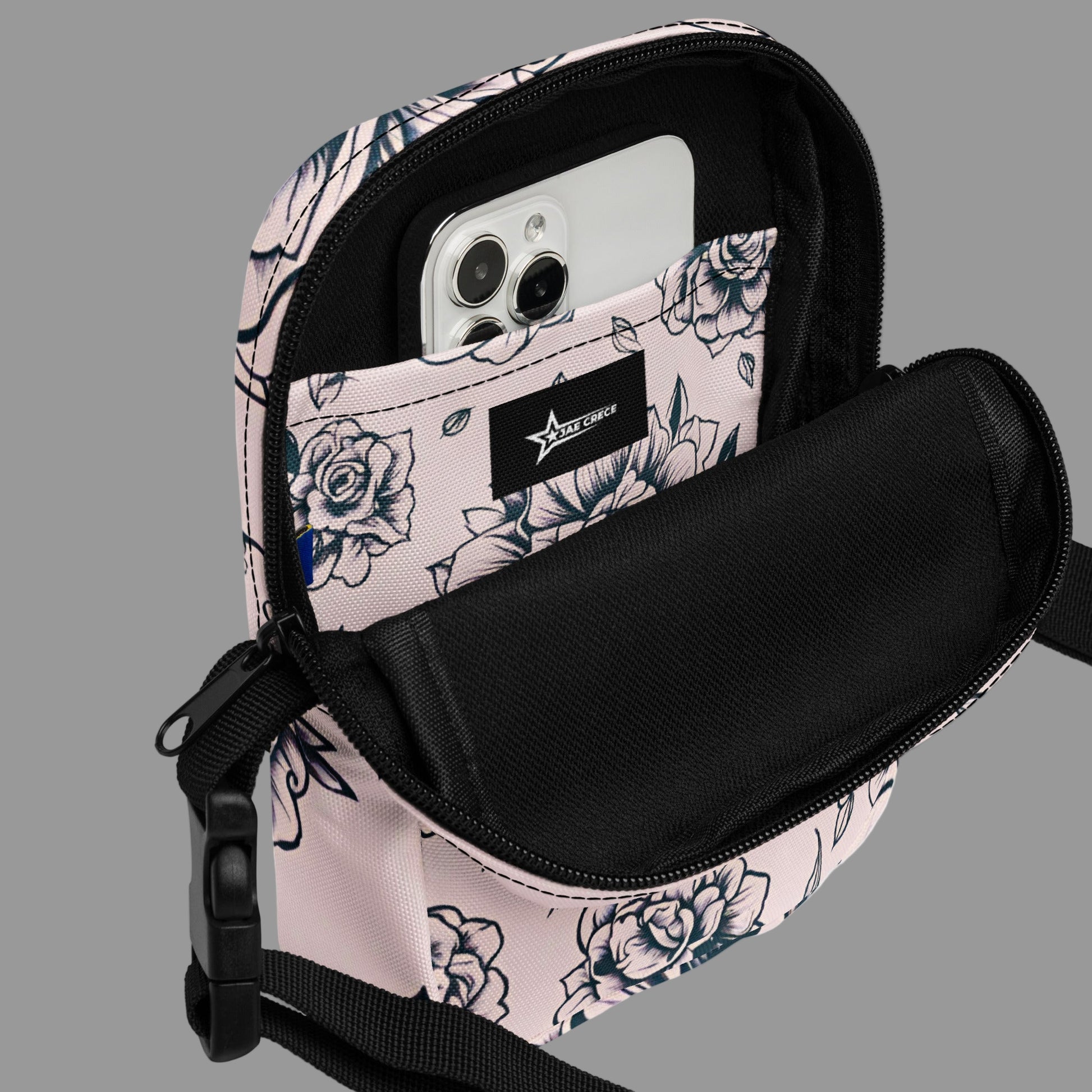 Edgy pink floral tattoo crossbody bag with adjustable strap, designed for fashion-forward individuals who love bold style and functionality. This small travel utility purse is lightweight, durable, and water-resistant, offering multiple compartments for easy organization. Perfect for daily errands, concerts, or festivals, this compact rose handbag blends trendy tattoo art with practical design for everyday use.
