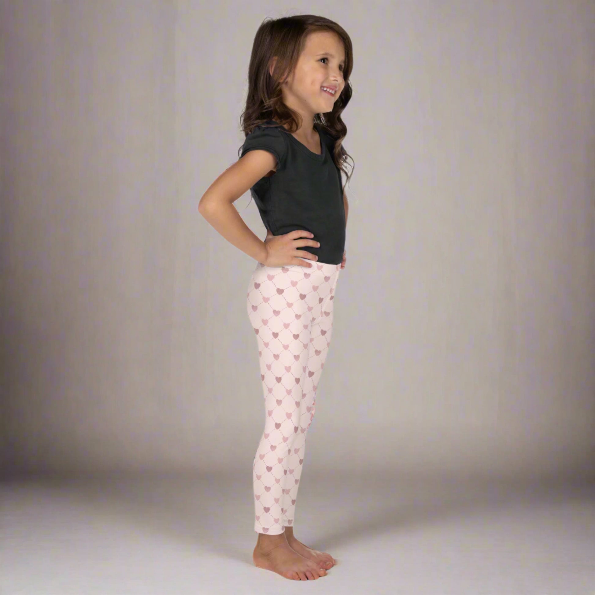 Image: Pink Hearts girls Leggings. These light pink leggings feature a trendy criss cross diamond pattern and pink hearts, perfect for toddlers and little girls. Available in sizes 2T-7, with matching adult yoga pants for stylish mommy and me outfits.
