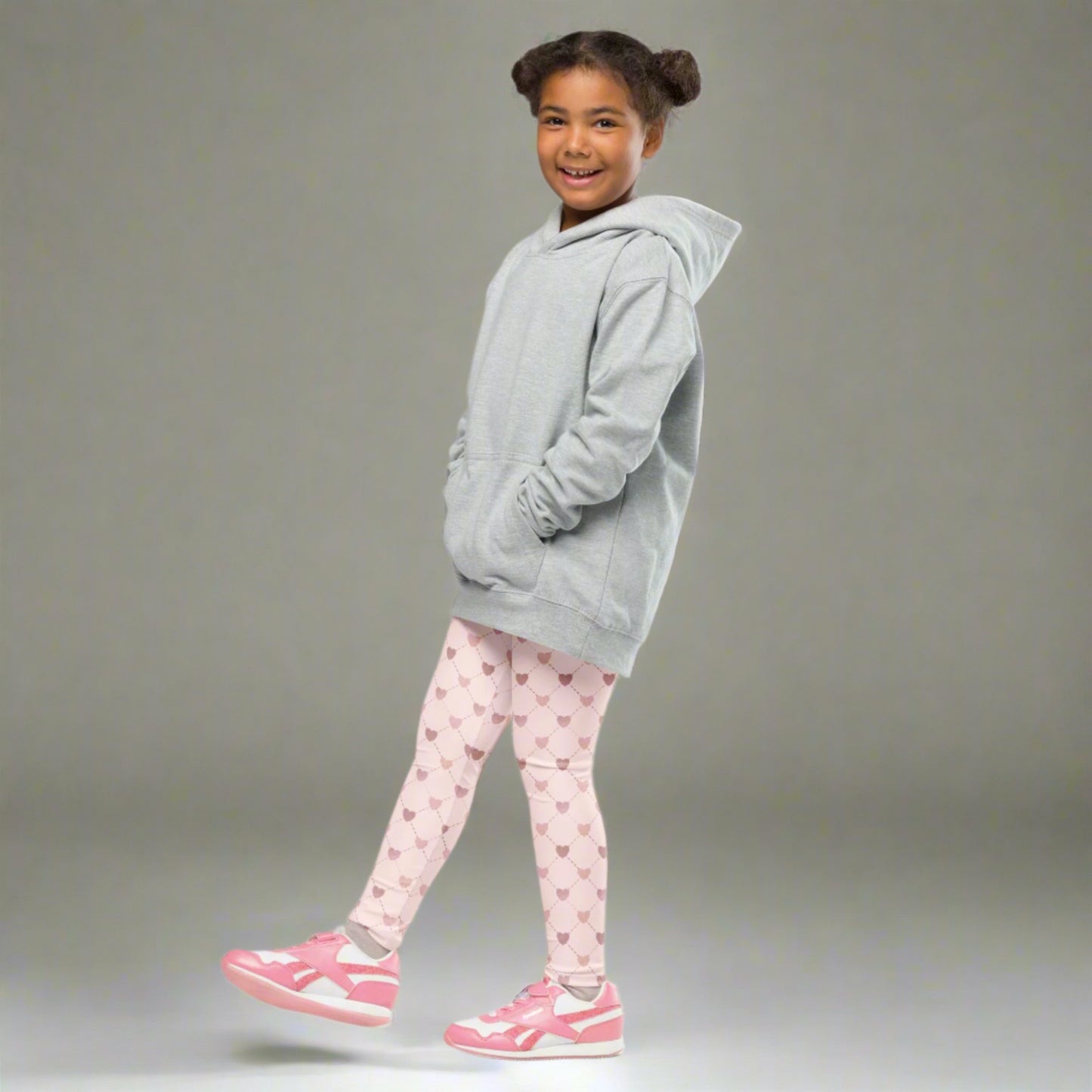 Image: Pink Hearts girls leggings. These light pink leggings feature a trendy criss cross diamond pattern and pink hearts, perfect for toddlers and little girls. Available in sizes 2T-7, with matching adult yoga pants for stylish mommy and me outfits, by jaecrece