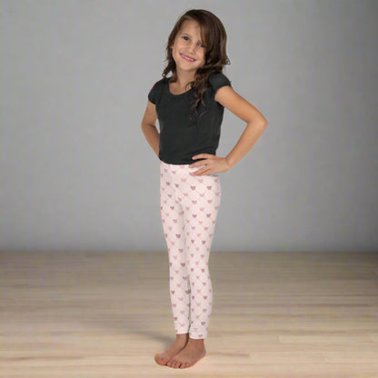Image: Pink Hearts toddler Leggings. These light pink leggings feature a trendy criss cross diamond pattern and pink hearts, perfect for toddlers and little girls. Available in sizes 2T-7, with matching adult yoga pants for stylish mommy and me outfits, by jaecrece