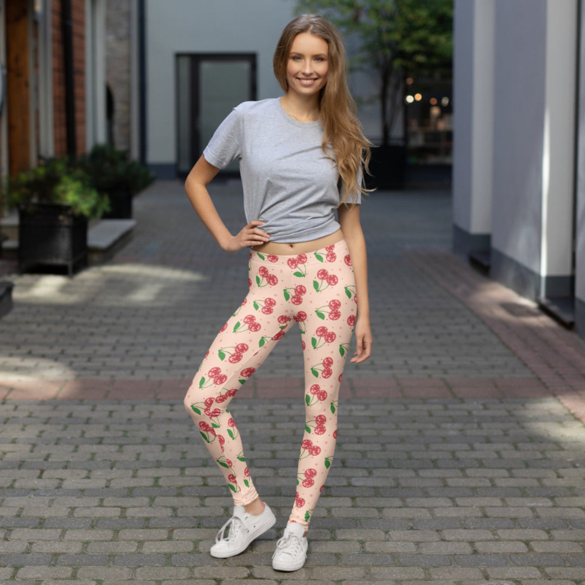 Disco cherry women’s leggings featuring a bright pink background with sparkling disco ball cherry print, full length leggings with a mid rise waist designed for women who love bold fashion, cherry aesthetic style, retro inspired outfits, playful athleisure wear, casual travel looks, lounge outfits, and statement leggings for everyday comfort