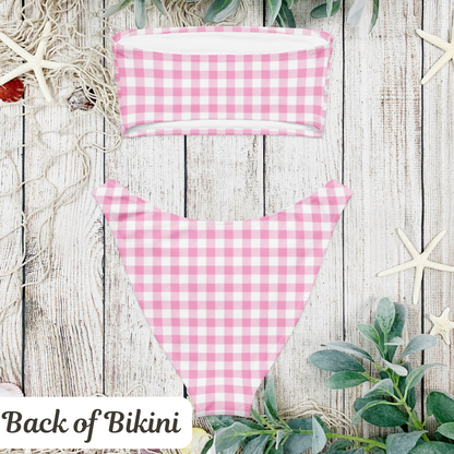 Coquette pink gingham bikini set with a strapless bandeau top, perfect for soft girl summer vibes and vintage fashion lovers. This retro-inspired swimsuit features a sweet checkered print in pastel pink and white, making it ideal for pool parties, bachelorette weekends, and beach vacations. A must-have swim look for girls embracing the cottagecore, TikTok, and dreamy picnic aesthetic.

