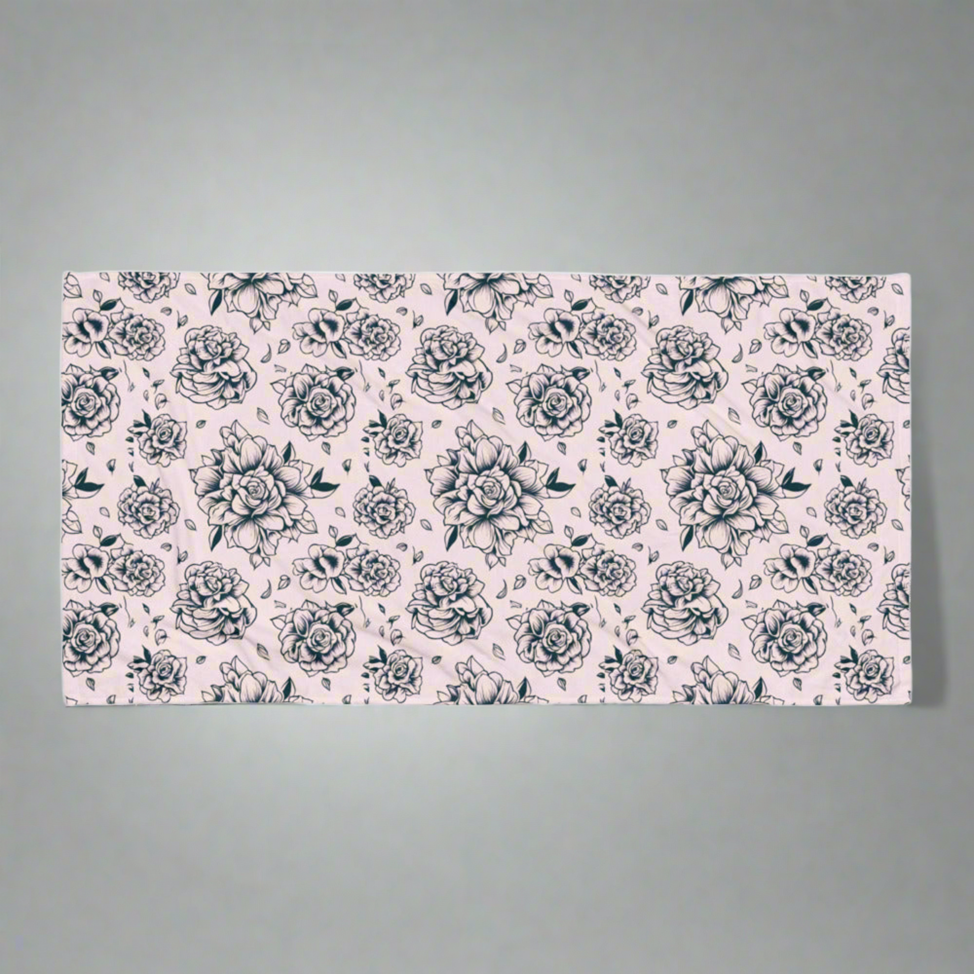 Pink Tattoo Rose Beach Towel flatlay on a neutral background, showing full 30×60″ oversized design with bold black and pink tattoo rose print, soft cotton blend with absorbent terry backing, perfect for pool, beach, lake, or travel use, lightweight and quick-drying, stylish summer accessory, coordinating with matching swimwear, statement floral towel for women, girls, and family, ideal for vacations, pool parties, and everyday lounging.