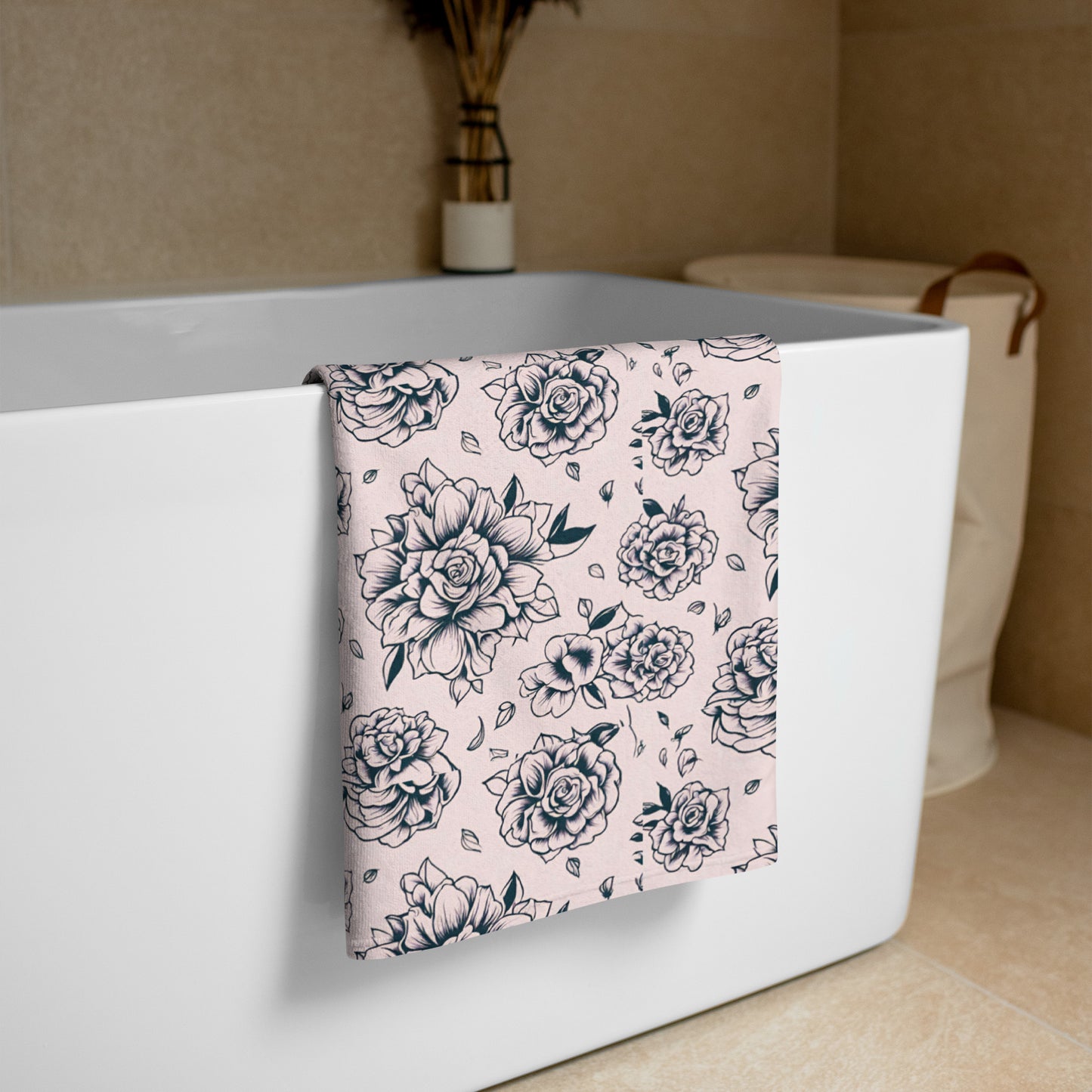 Pink Tattoo Rose Beach Towel hanging over the side of a bathtub, showing full 30×60″ oversized design with bold black and pink tattoo rose print, soft cotton blend with absorbent terry backing, perfect for bathroom, pool, or beach use, quick-drying and lightweight, statement floral towel for women, girls, and family, coordinating with matching swimwear, stylish summer accessory for travel, lake days, and everyday lounging.