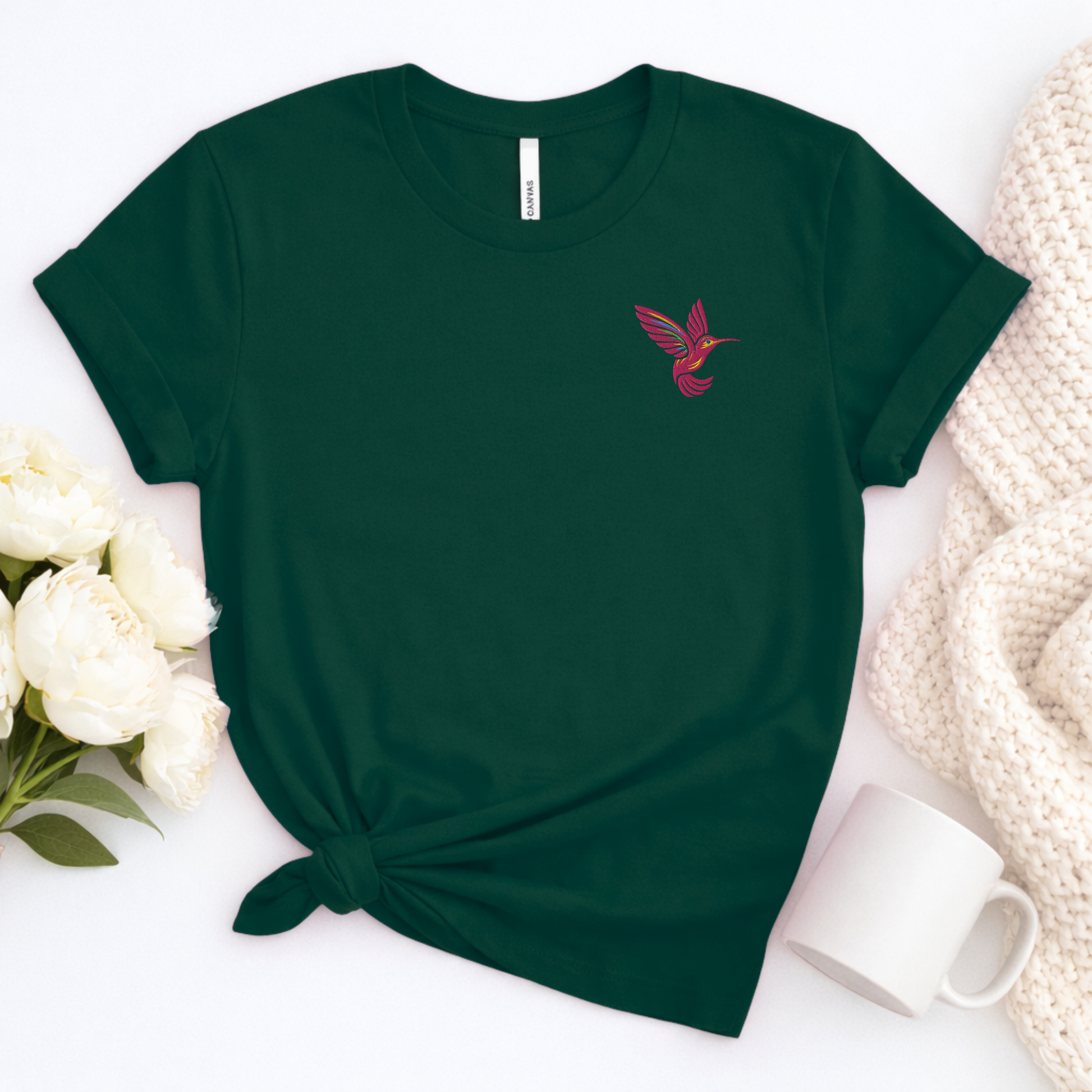 Pink hummingbird embroidered tee for women featuring a single detailed hummingbird on the left chest, a minimalist bird lover shirt perfect for nature lovers, gardeners, bird watchers, spring outfits, casual wear and thoughtful hummingbird lover gifts
