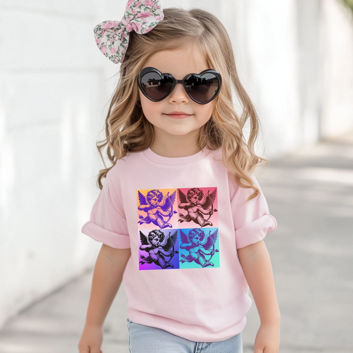 The Pop Art Cupid Toddler T-shirt, available in sizes 2T-5T, combines a bold, vintage Cupid graphic with soft, comfortable fabric. Available in Black, White, and Pink, this stylish tee is perfect for toddlers who love retro-inspired fashion and playful designs. Whether it’s for casual everyday wear or family matching outfits, this artsy t-shirt captures the fun of pop culture while keeping little ones comfortable and looking cute.