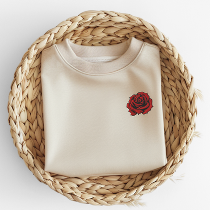 Flatlay of a Sand embroidered rose sweatshirt showcasing bold red floral embroidery on the chest and soft cotton polyester fabric. The classic fit and durable stitching are highlighted, making it ideal for cozy everyday wear, layering, or lounging. Perfect as a thoughtful June birth flower gift, birthday or anniversary present, or Valentine’s Day gift for women who love romantic floral embroidery and timeless style.