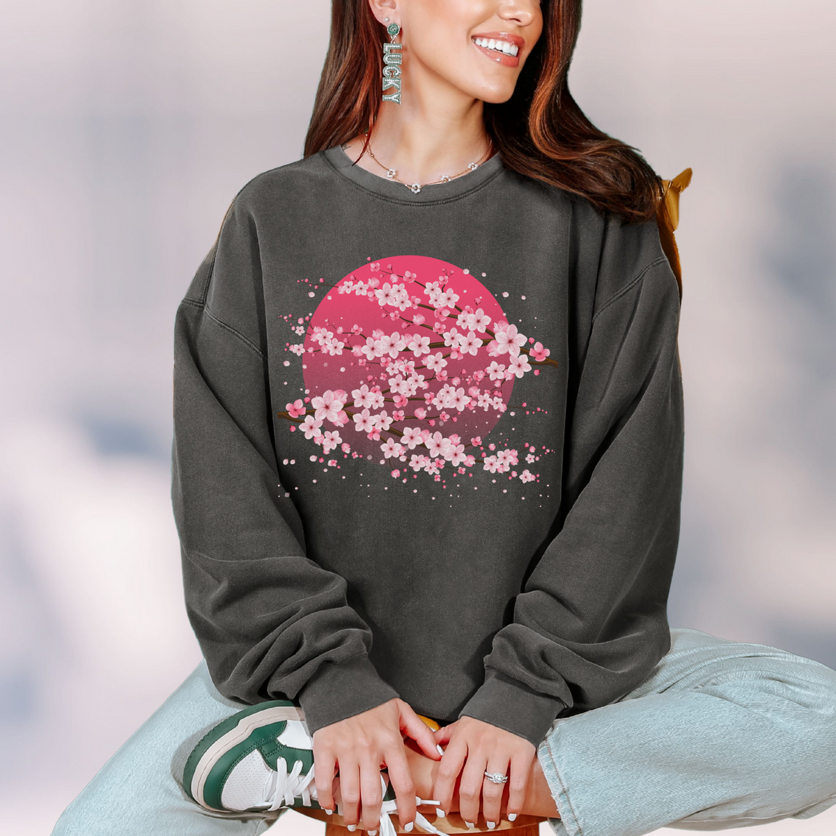 Comfort Colors 1466 cherry blossom sweatshirt shown with its relaxed fit, ribbed cuffs, ribbed hem, and soft garment dyed finish. The pullover is made from 100 percent ring spun cotton and designed for a comfortable lived in feel. Available in Black, White, Blue Jean, Ivory, and Pepper in sizes Small through 3XL.