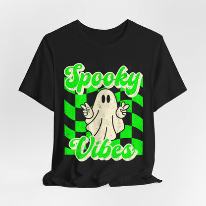 Retro Halloween ghost tshirt on a black Bella Canvas 3001 featuring a peace sign ghost and bold green checkerboard design with Spooky Vibes text. Lightweight soft cotton unisex shirt in sizes S to 3XL plus matching kids sizes for sibling and family matching sets. Ideal for boo crew events, school spirit days, Halloween travel outfits, haunted attractions, costume alternative looks, and stylish spooky season wardrobes all October long.