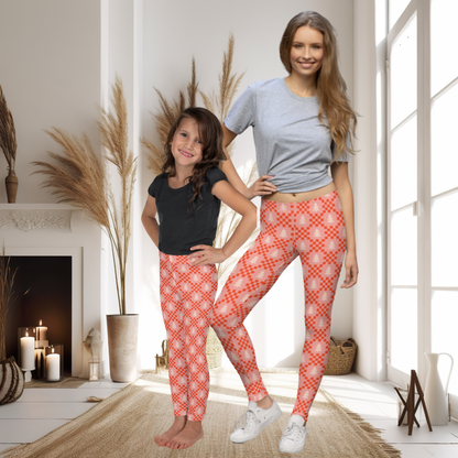 Pink Christmas tree girls leggings with a nostalgic retro holiday aesthetic. The print combines cream evergreen trees and red geometric details on a soft pink background, creating the look of a colorful vintage inspired Christmas sweater. These full length leggings are a fun choice for girls who love pink Christmas decor, festive outfits, nostalgic holiday style, or a playful alternative to traditional Christmas clothing.