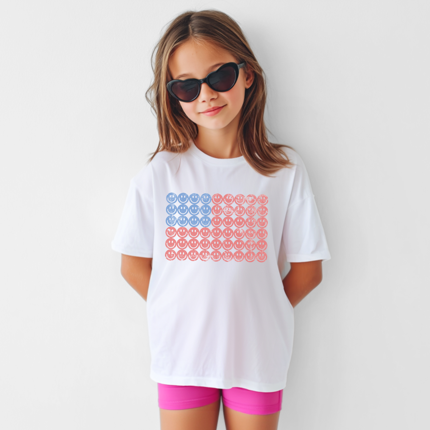 Kids American flag smiley face graphic tee on a white cotton shirt, playful USA shirt for children, patriotic holiday outfits, fireworks, parades, and summer adventures