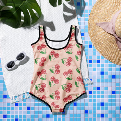 Retro fruit inspired swimsuit for toddlers, kids, tweens, and teens featuring disco cherries and stars on a bright pink background.
