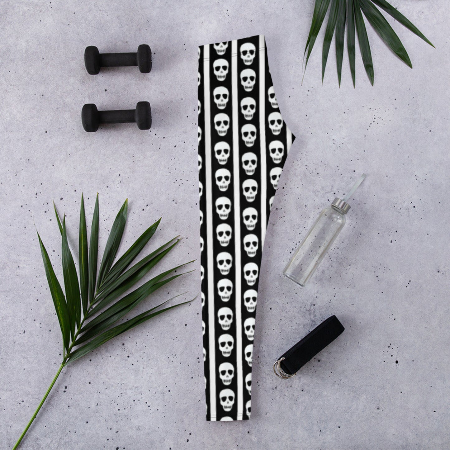 Image: These striped skull leggings combine a love of bold pattern and edgy detail. Featuring vertical black and white stripes with skulls stacked neatly down each leg, they offer a balance of fun and fierce. Perfect for dance practice, spooky themed workouts, or casual hangouts with a twist, these leggings are available in women’s sizes XS to XL and made to move with you, by jaecrece.