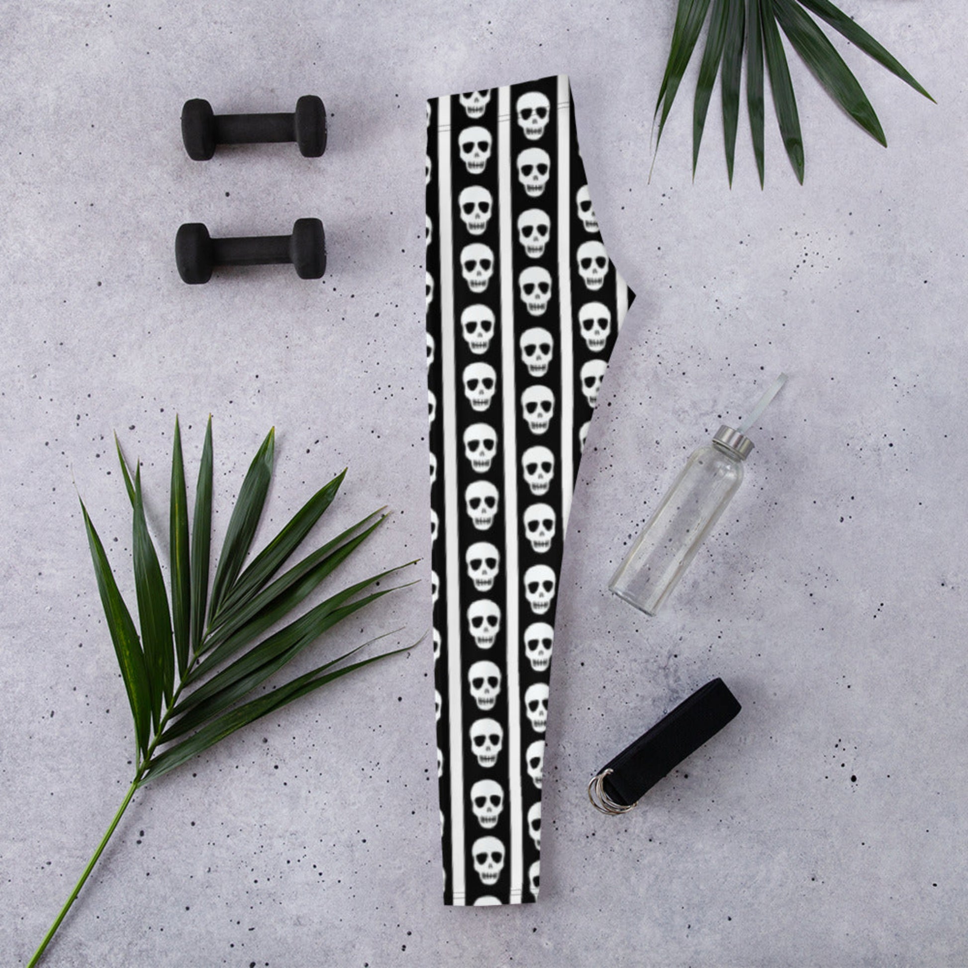 Image: These striped skull leggings combine a love of bold pattern and edgy detail. Featuring vertical black and white stripes with skulls stacked neatly down each leg, they offer a balance of fun and fierce. Perfect for dance practice, spooky themed workouts, or casual hangouts with a twist, these leggings are available in women’s sizes XS to XL and made to move with you, by jaecrece.