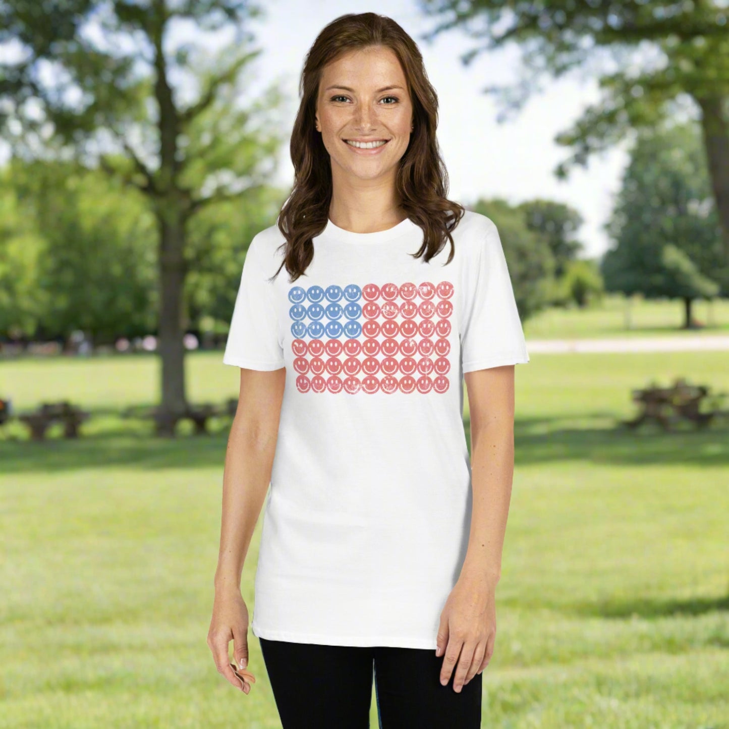 Smiley face American flag shirt featuring a red white and blue graphic design on a white unisex t-shirtThis white adult t-shirt features a retro American flag graphic made of smiley faces, blending patriotic flair with playful vintage style. Made from soft, organic cotton, this eco-friendly Fourth of July shirt is perfect for barbecues, fireworks, parades, or casual summer wear. Ideal for those who love retro American flag designs, minimalist patriotic fashion, and sustainable summer style with a fun twist.
