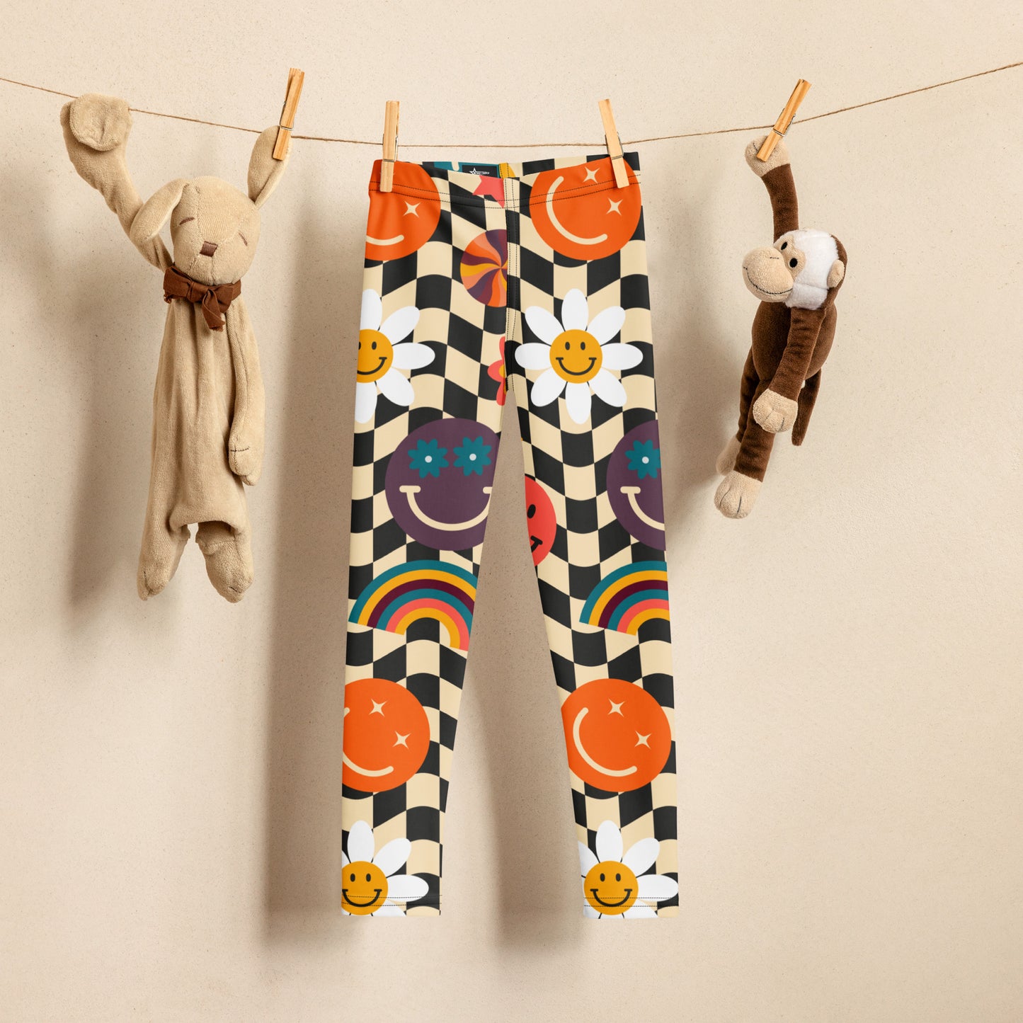 Smiley Face Checkerboard Girls Leggings in sizes 2T–7 feature a bold beige and black wavy checkerboard print with playful daisies, colorful rainbows, and cheerful smiley faces. These toddler and little girl leggings are soft, stretchy, and durable, making them perfect for everyday wear, playdates, or school outfits. A fun choice for matching family leggings with youth sizes 8–20 and women’s XS–XL.
