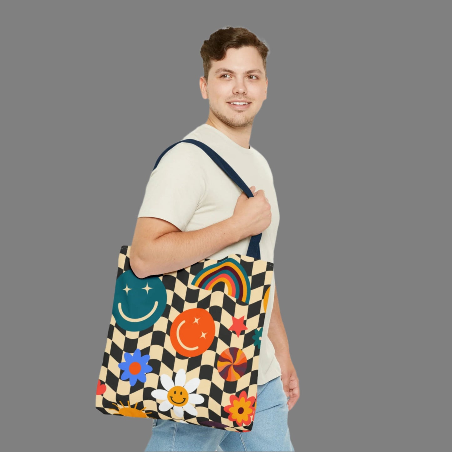 Smiley Face Checkerboard Canvas Tote Bag. This cute reusable carryall is eco friendly, and features a black and khaki checkerboard background, with smiley face, rainbow and daisy graphics. by jaecrece.com