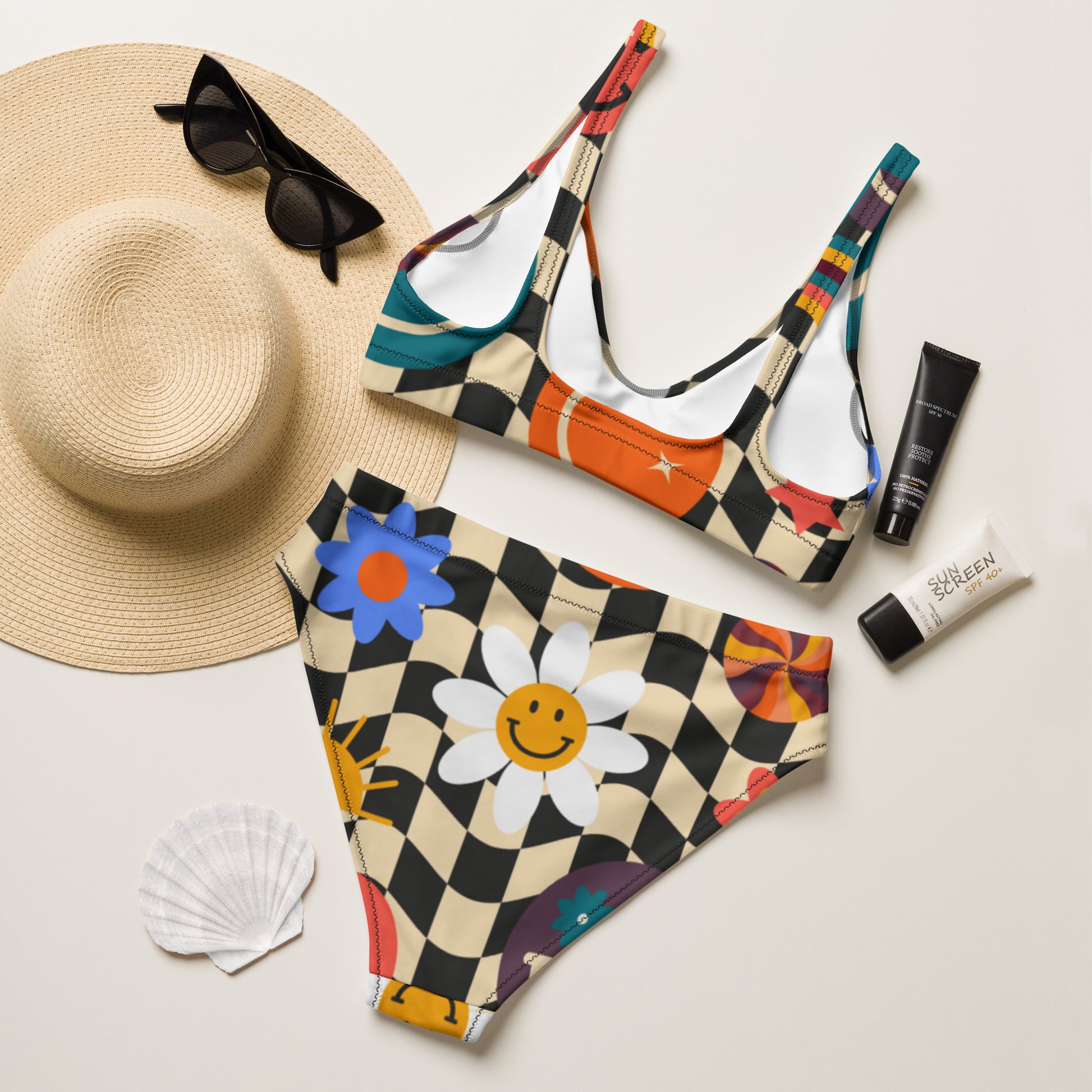 Playful summer bikini featuring a smiley face checkerboard print and a flattering high waisted silhouette. This recycled two piece swimsuit is soft supportive and double layered for coverage making it ideal for swimming sunbathing and vacation wear. A fun modern take on retro inspired beachwear.