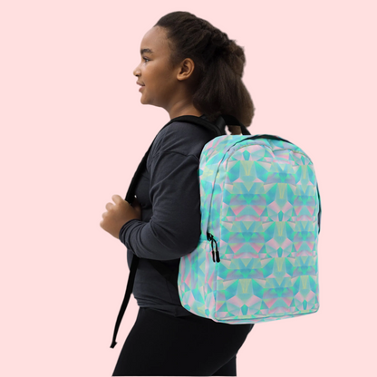 Colorful pastel backpack shown from the front, highlighting a geometric prism print and clean finished details. This everyday backpack features a spacious interior compartment, a separate pocket for a 15 inch laptop, a hidden back zipper pocket for valuables, and padded ergonomic straps. Designed for teens, college students, and pastel lovers looking for a cute school backpack with practical storage.
