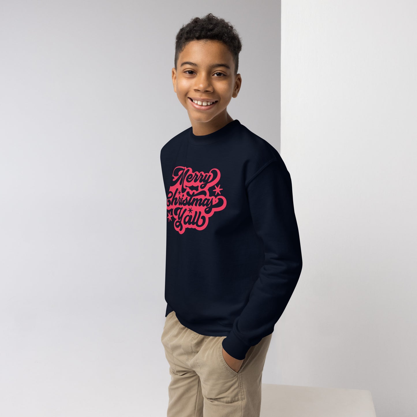 Red script youth sweatshirt says "Merry Christmas Y’all," bringing southern flair to your child's holiday wardrobe. Crafted from pre-shrunk cotton and polyester, this Gildan 18000B sweatshirt is soft, warm, and ideal for holiday fun. A stylish and thoughtful gift for the season.