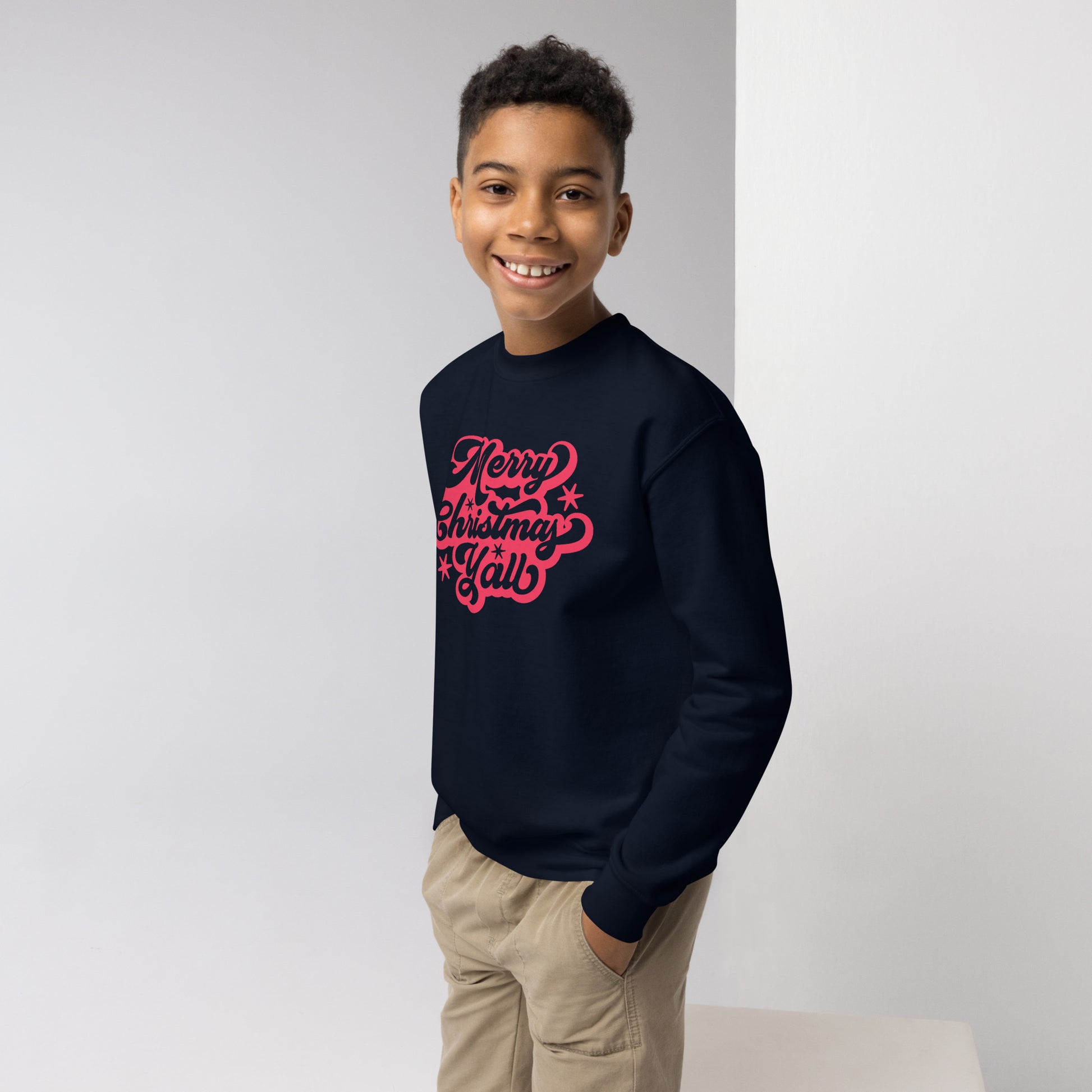 Red script youth sweatshirt says "Merry Christmas Y’all," bringing southern flair to your child's holiday wardrobe. Crafted from pre-shrunk cotton and polyester, this Gildan 18000B sweatshirt is soft, warm, and ideal for holiday fun. A stylish and thoughtful gift for the season.