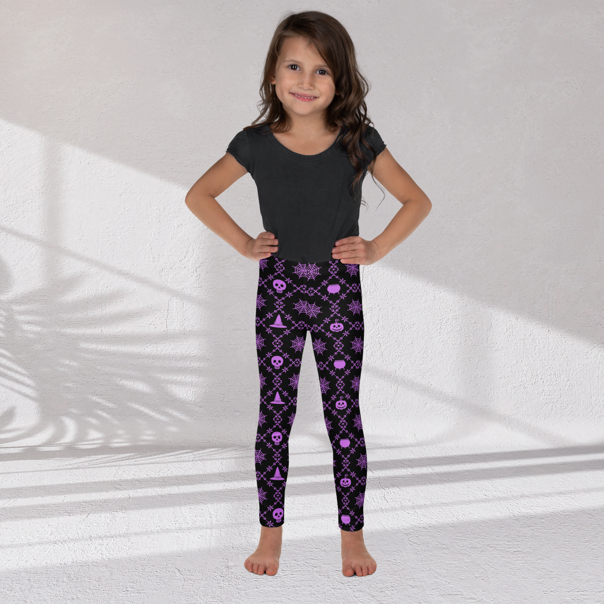 Full length Halloween leggings for girls with a high rise waist and vibrant purple geometric spooky print on black, comfortable kids leggings for toddlers, girls, tweens and teens, perfect for fall outfits, Halloween school events, trick or treating and pumpkin patch visits