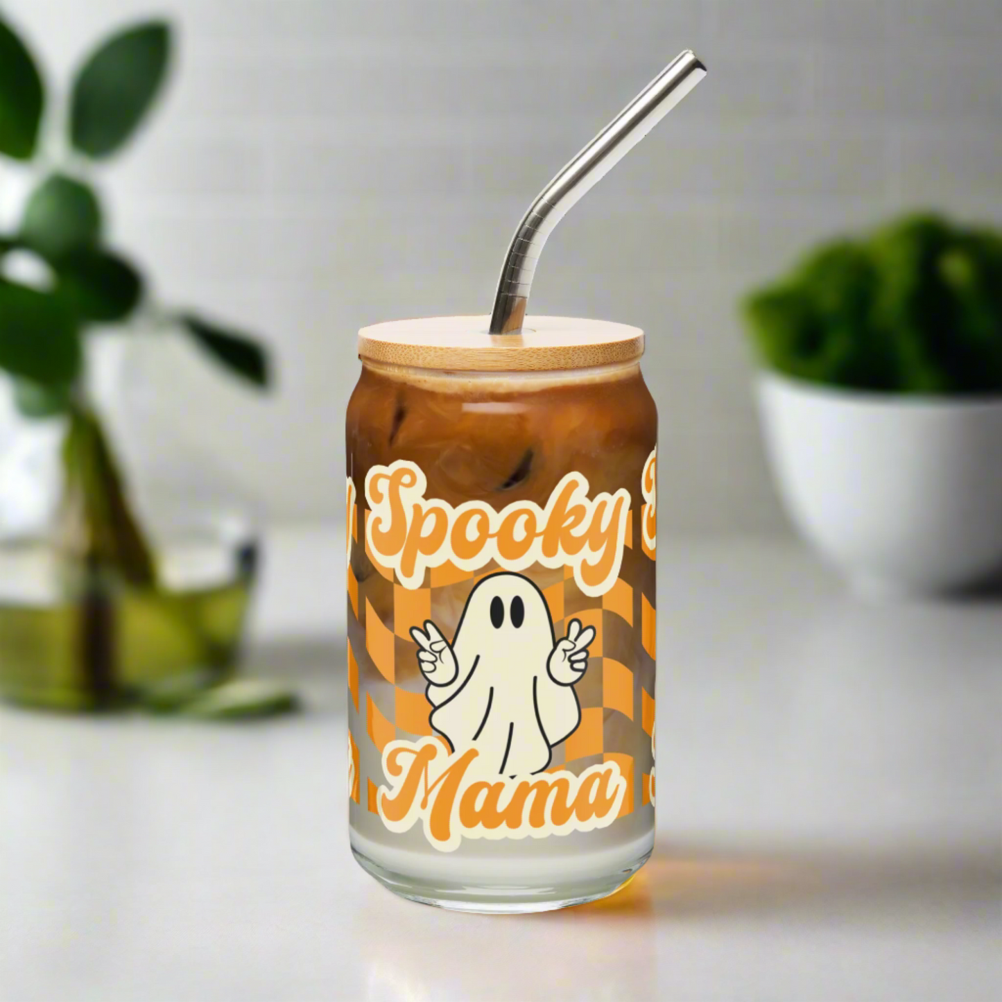 Cute Halloween drink cup for moms and friends, Spooky Mama glass tumbler with bamboo lid and straw, 16 oz iced coffee glass for fall drinks. Orange and white ghost print gives cozy spooky season vibes. Great Halloween gift idea for coffee lovers, sustainable drinkware collectors, or anyone celebrating autumn in style.