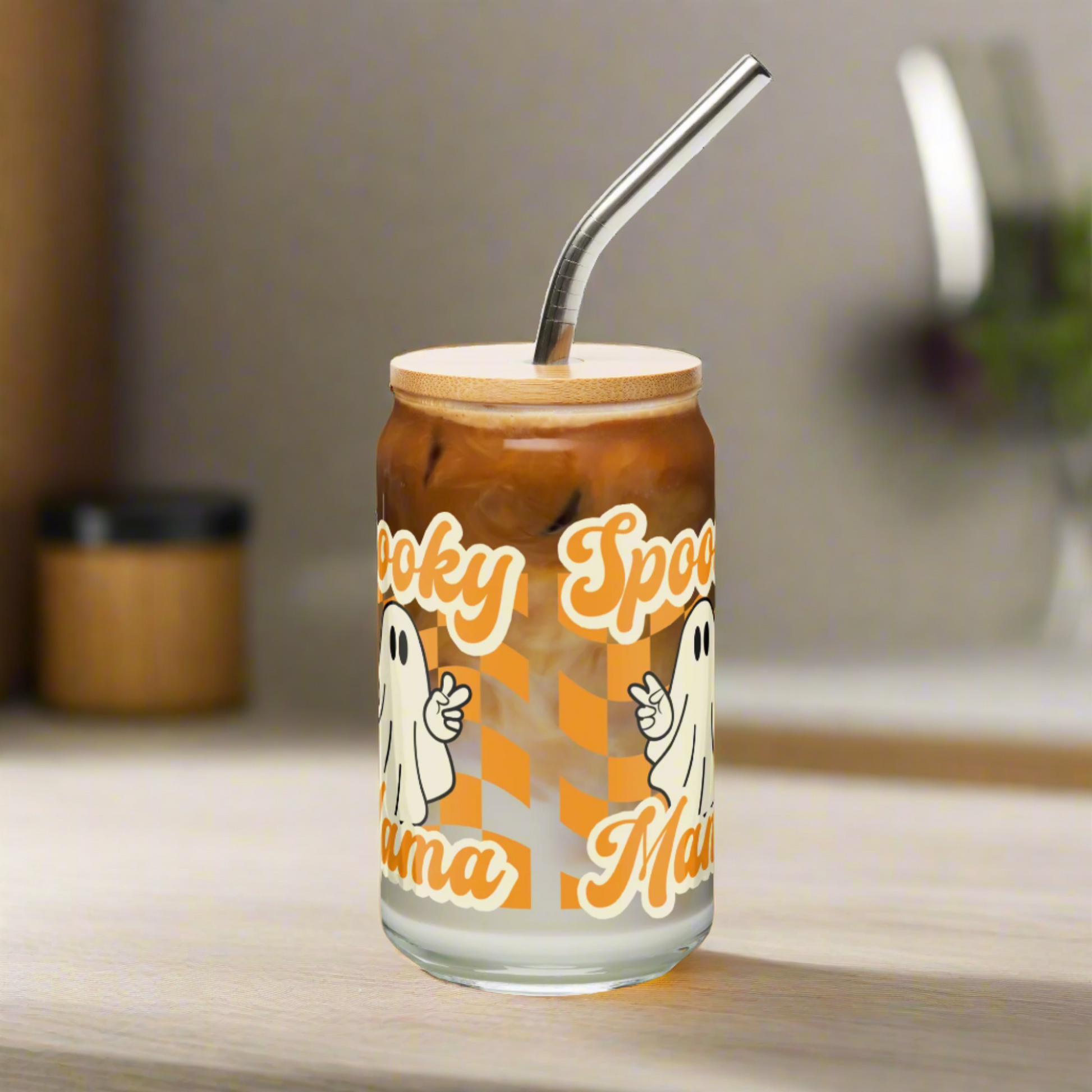 Spooky Mama sipper glass with bamboo lid and metal straw, perfect Halloween drinkware for iced coffee or fall cocktails. This 16 oz ghost cup features an orange checkerboard pattern with playful ghost art and makes the ideal Halloween gift for moms, friends, and iced coffee lovers. Eco friendly and reusable, this cute Halloween tumbler adds charm to every spooky season sip.