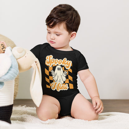 Black baby bodysuit featuring a Spooky Mini Vibes Halloween design with a smiling ghost, orange and cream lettering, and a retro distressed background. Perfect for baby's first Halloween, spooky season outfits, family pictures, and coordinating Halloween clothes.
