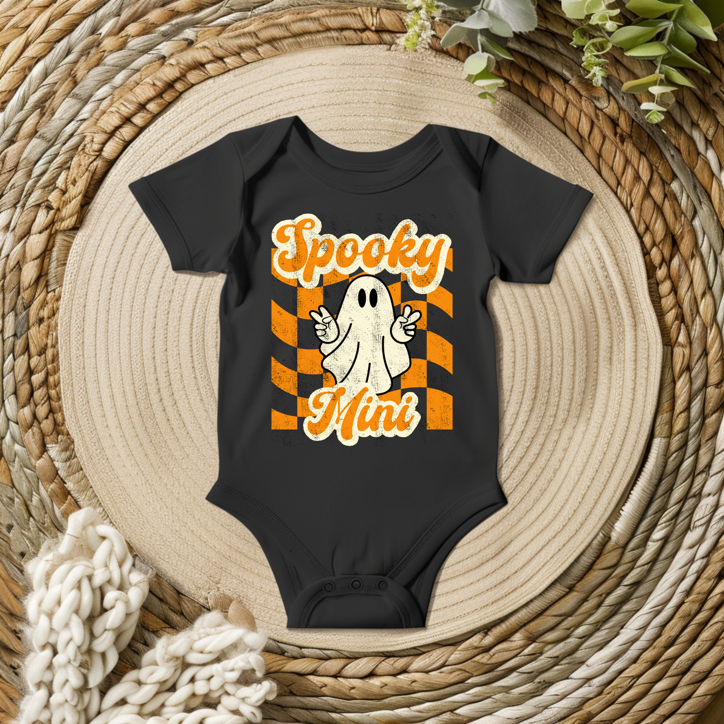 Spooky Mini Vibes baby Halloween bodysuit in black, orange, and cream featuring a playful vintage inspired ghost, distressed lettering, and bold Halloween stripes. A cute choice for baby's first Halloween, family Halloween photos, pumpkin patch visits, and matching family outfits.