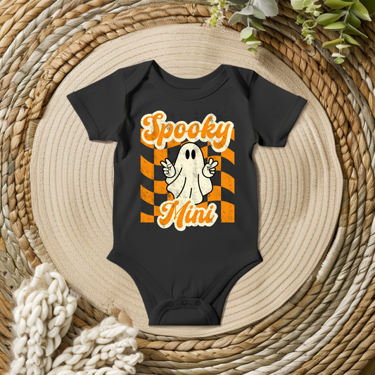 Spooky Mini Vibes baby Halloween bodysuit in black, orange, and cream featuring a playful vintage inspired ghost, distressed lettering, and bold Halloween stripes. A cute choice for baby's first Halloween, family Halloween photos, pumpkin patch visits, and matching family outfits.