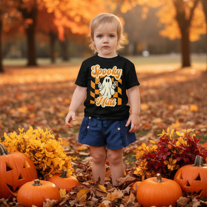 Spooky Mini Vibes toddler Halloween shirt in black, orange, and cream featuring a playful ghost, retro lettering, and distressed Halloween graphics. A fun toddler Halloween outfit for pumpkin patch visits, family photos, Halloween parties, and matching family outfits.