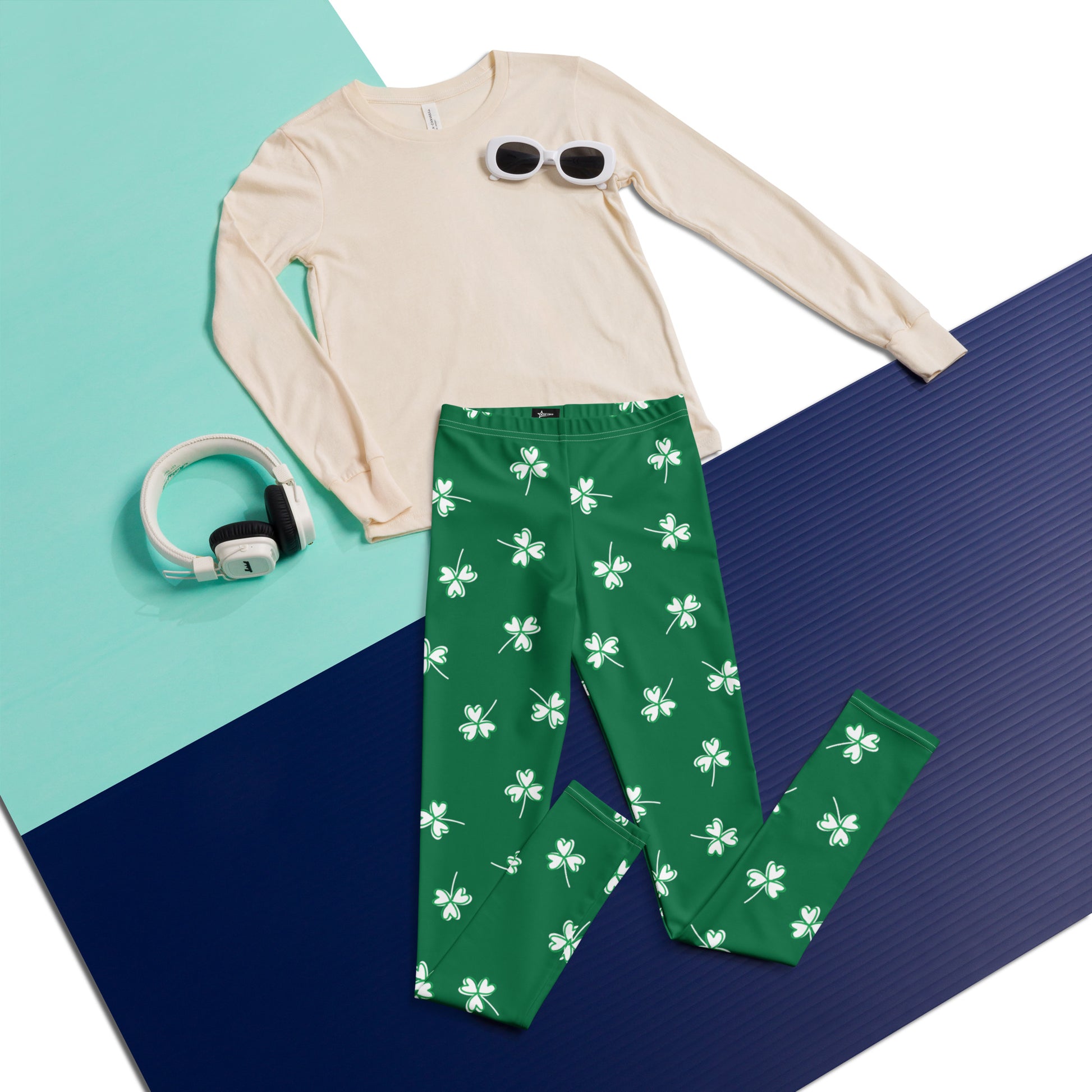 Image: Family Matching St Patricks Day Shamrock Leggings. Festive yoga pants with green background and white four leaf clovers. Available in sizes for toddler girls, teens, tweens, and women. Perfect for a St Pattys Day parade or fun run, by jaecrece