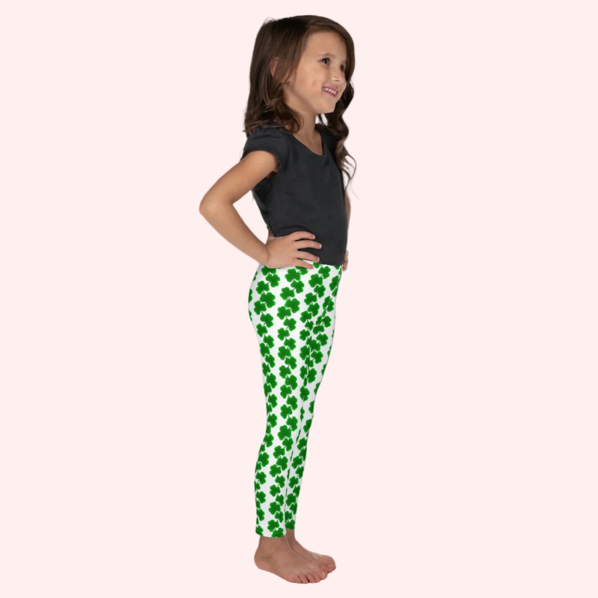 Image: St Patricks Day Leggings for toddlers and girls. Celebrate St. Patrick’s Day with these adorable girls’ leggings for toddlers and kids, featuring green shamrock chains on a bright white background. With a full-length fit and high-rise waistband, these leggings are comfy, festive, and fun. Designed to match with youth and women’s sizes for a cute and coordinated family outfit during March celebrations. Also available in tween girl and womens sizes for family matching outfits, by jaecrece