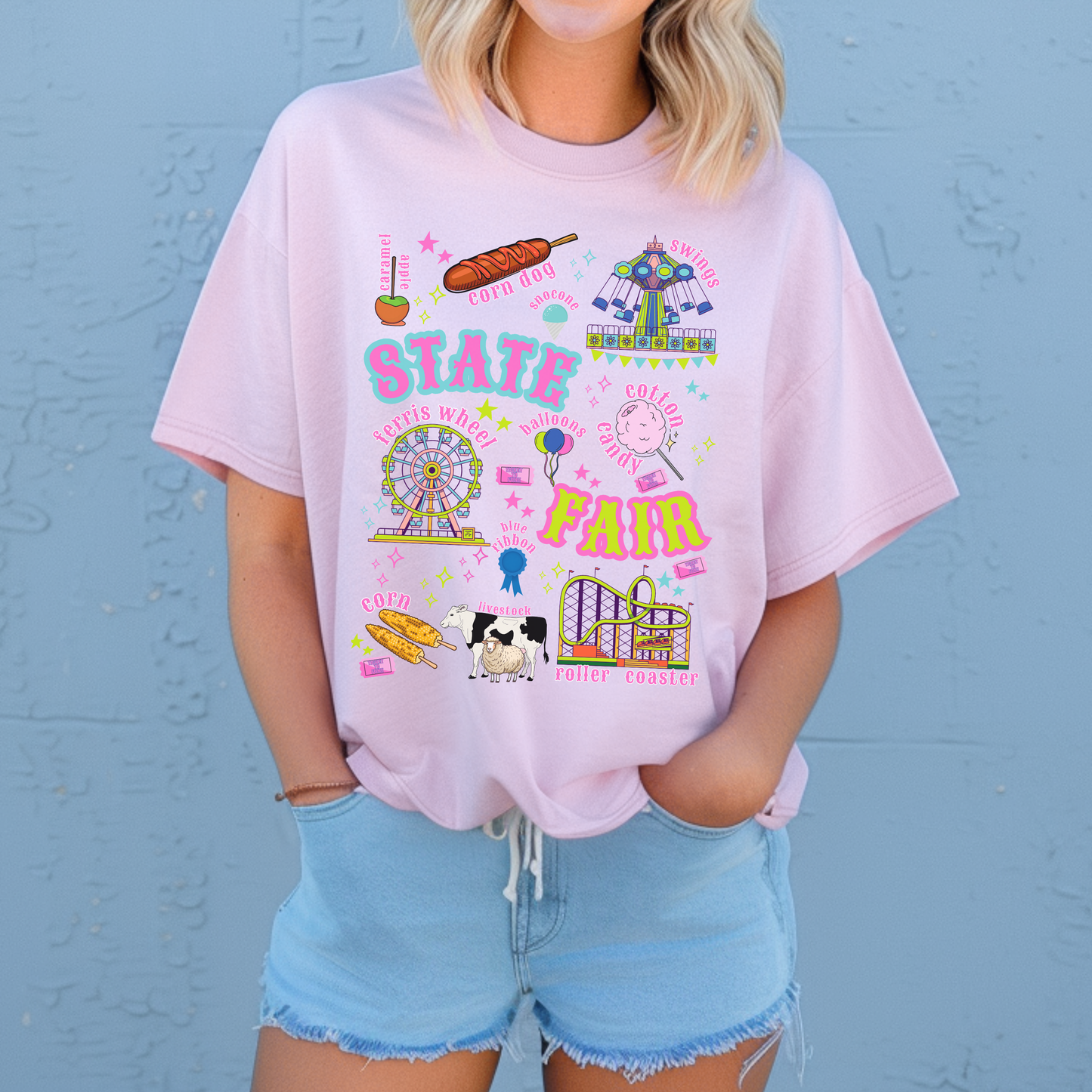 Retro carnival artwork for a state fair T shirt includes a Ferris wheel, roller coaster, swing ride, cotton candy, balloons, funnel cake, corn dogs, livestock, prize ribbon and fair tickets. Bright pink, aqua, lime, orange and purple details give the graphic a playful vintage Americana feel with a retro summer feel.