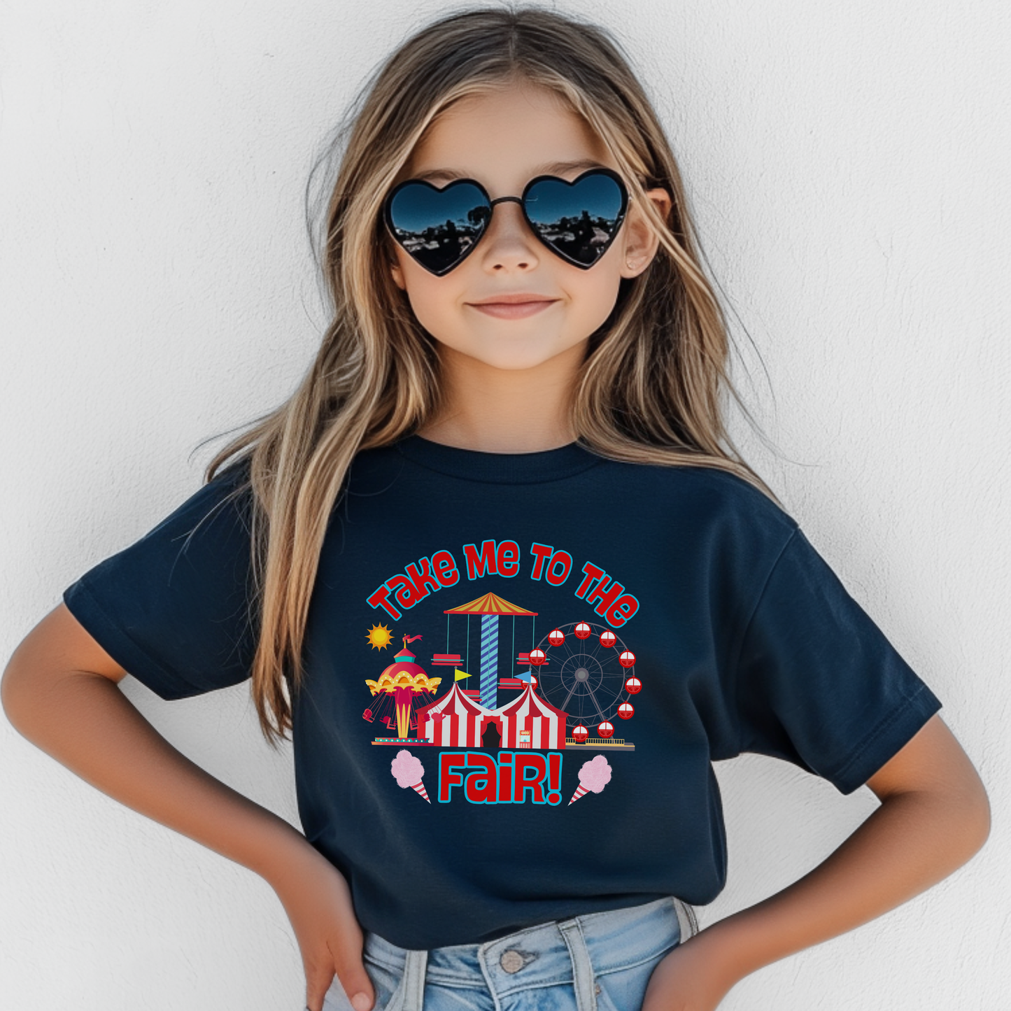 Take Me To The Fair graphic kids tee with colorful Ferris wheel, carnival rides, striped fair tent, cotton candy, and retro fair artwork.