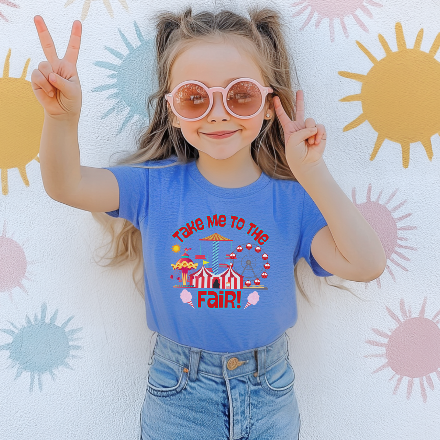 Cute Take Me To The Fair graphic shirt featuring colorful carnival rides, Ferris wheel, cotton candy, striped fair tent, and retro inspired fair artwork.