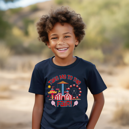 Young boy wearing a Crewneck tee that reads take me to the fair with a fairground graphic of rides and cotton candy