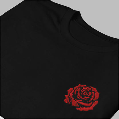 Image: This soft and cozy embroidered pullover features a delicate yet bold red rose, evoking the beauty of traditional tattoo artistry. Designed for comfort and style, it is perfect for casual wear or layering on cooler days. Ideal as a thoughtful gift, this sweatshirt makes a statement while maintaining a timeless, floral elegance. Celebrate the beauty of roses and artistic expression with this stunning embroidered design, by jaecrece.