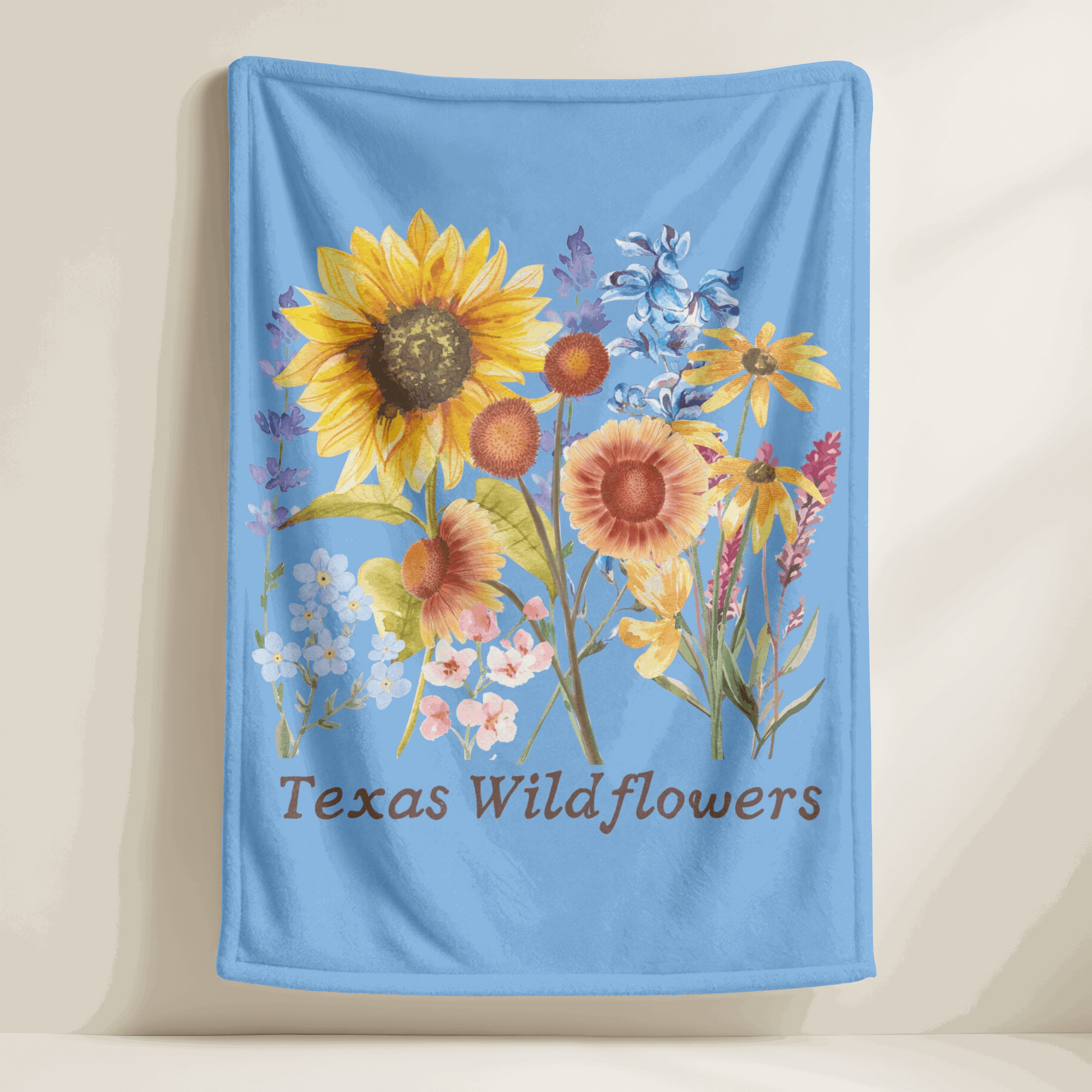 This Texas floral throw blanket showcases a charming wildflower print with watercolor bluebonnets, sunflowers, and delicate pastel greenery. Ideal for spring home decor, baby gifts, or cozying up on the couch, this plush blanket celebrates Texas nature and southern charm. It's a soft and snuggly gift for moms, gardeners, and fans of wildflower or botanical print home accents.

