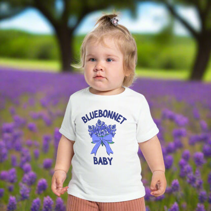 Image: This Texas-inspired baby t-shirt features a beautiful bluebonnet print, perfect for toddlers who love nature. Designed for comfort, it’s great for family outings, spring festivals, or playdates. The lightweight fabric makes it ideal for warm weather, while the charming floral design adds a touch of Texas charm. A thoughtful baby shower or birthday gift, this tee is a great way to introduce little ones to their state’s beloved wildflower, by jaecrece.