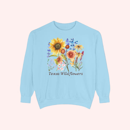 Bluebonnet floral sweatshirt celebrating wildflower season in Texas with a soft cotton fleece feel. Features a vintage-style graphic of spring blooms, perfect for the cottagecore girl or Southern mama. Designed with comfort in mind, this cozy pullover is perfect for layering on breezy days and capturing the spirit of Texas nature trails and wildflower festivals.