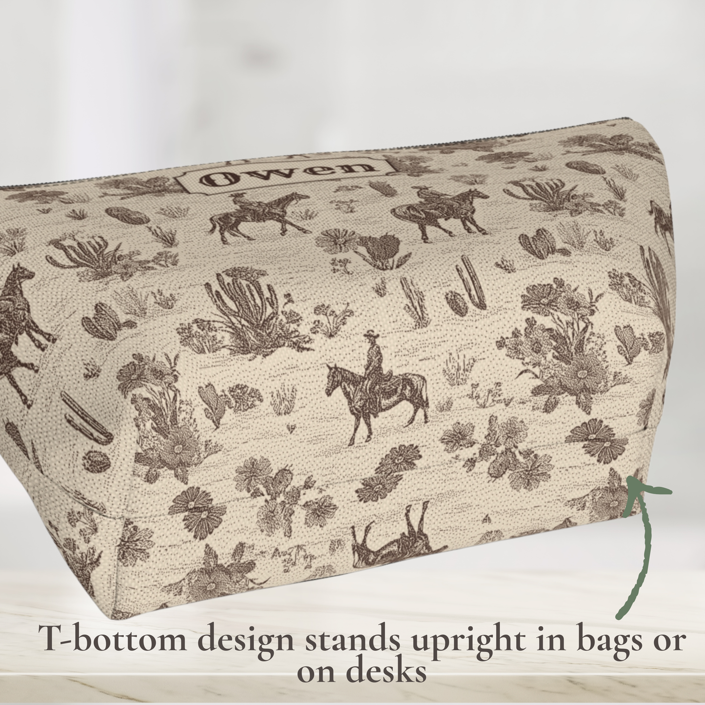 Personalized cowboy travel pouch in a vintage brown and cream Western toile design. Detailed illustrations of horseback riders, horses, cacti and desert plants create a classic ranch aesthetic. This custom toiletry bag is ideal for travel, overnight bags, weekenders, grooming supplies and everyday Western accessories.