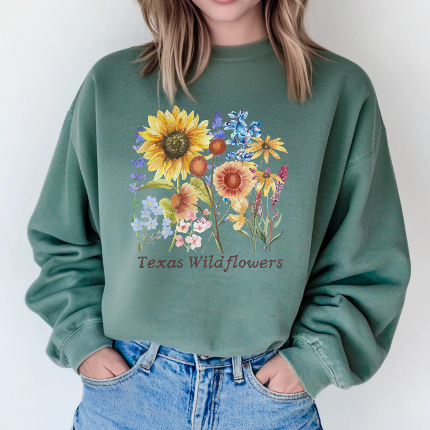 Texas Wildflowers Sweatshirt featuring hand drawn bluebonnets, Indian paintbrush, and golden coreopsis in soft vintage tones. Printed on cozy fleece, this floral crewneck brings soft girl, cottagecore, and Texas country aesthetic into one comfy top. Ideal for spring drives through Hill Country, floral festivals, or casual nature inspired outfits for women who love blooming Texas landscapes.