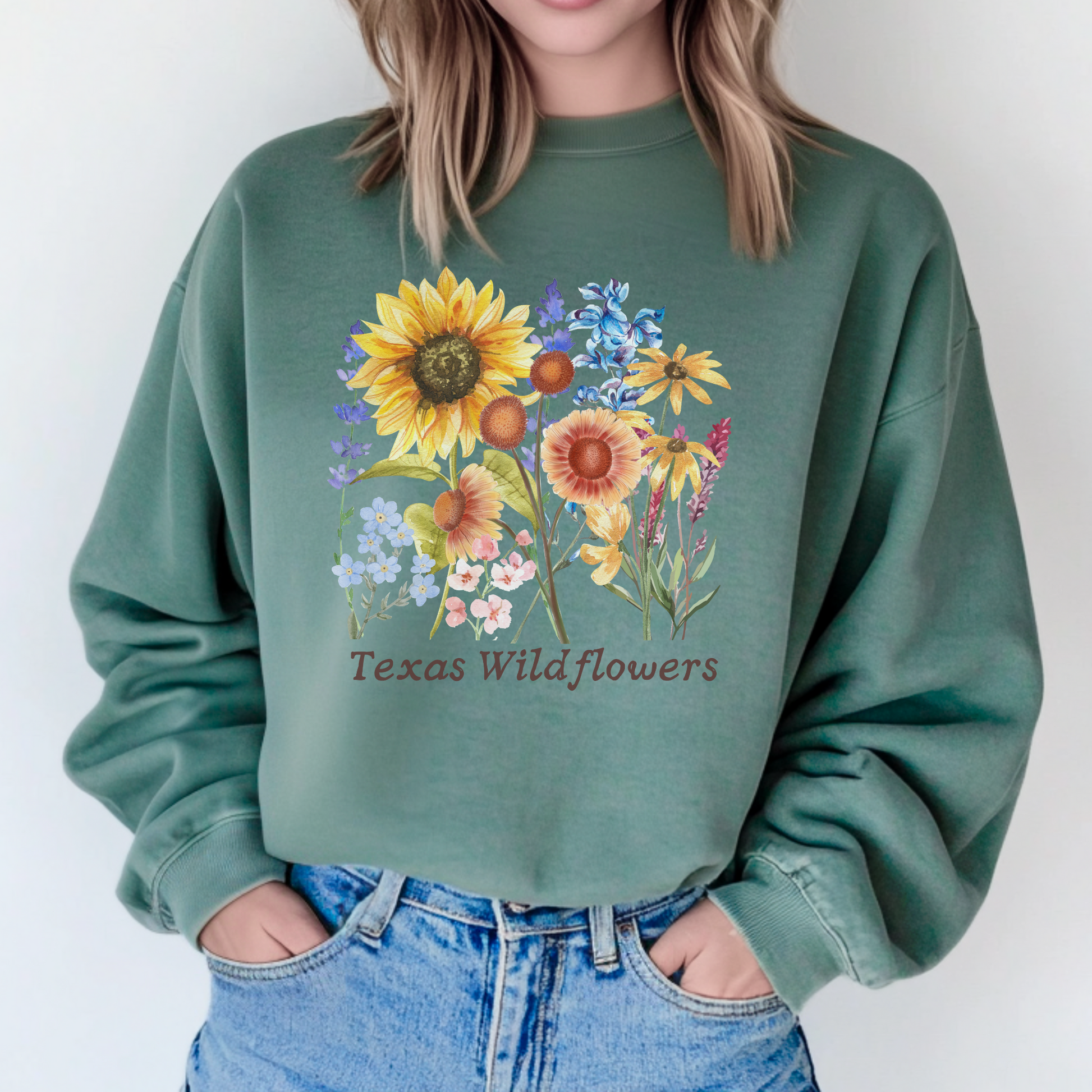 Texas Wildflowers Sweatshirt featuring hand drawn bluebonnets, Indian paintbrush, and golden coreopsis in soft vintage tones. Printed on cozy fleece, this floral crewneck brings soft girl, cottagecore, and Texas country aesthetic into one comfy top. Ideal for spring drives through Hill Country, floral festivals, or casual nature inspired outfits for women who love blooming Texas landscapes.