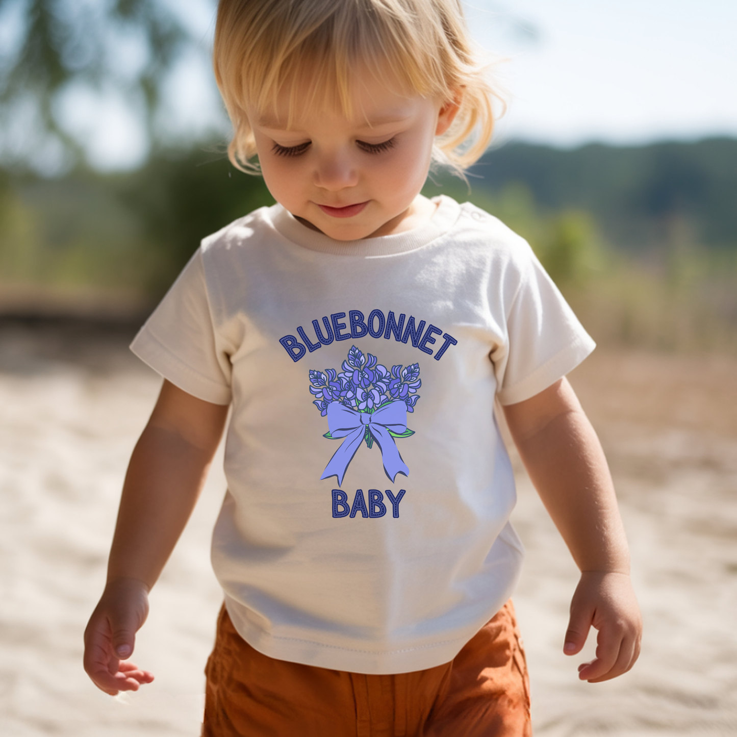 Texas bluebonnet baby shirt shown in White and Athletic Heather, available in infant sizes 3 to 6 months through 18 to 24 months, making a sweet Texas themed baby outfit for spring photos, family pictures and everyday adventures