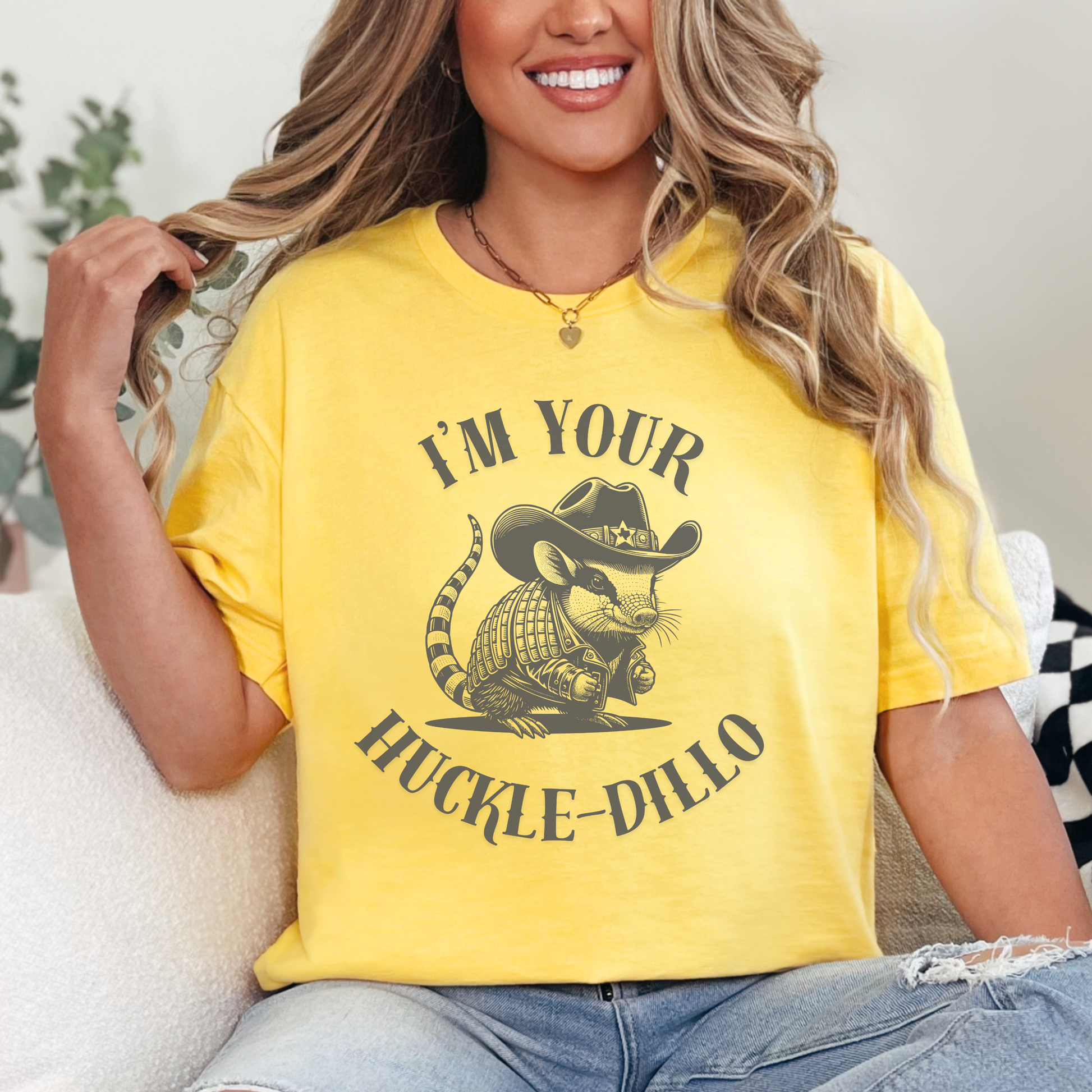 Image: A charming and humorous armadillo T-shirt featuring a detailed dark grey illustration of an armadillo sheriff. Dressed in a cowboy hat with a Texas emblem and a rugged western jacket, this design captures the fun spirit of Texas wildlife. A great choice for armadillo fans, country music lovers, or anyone with a love for funny animal shirts. Whether given as a gift or worn casually, this tee adds a playful western touch, by jaecrece.