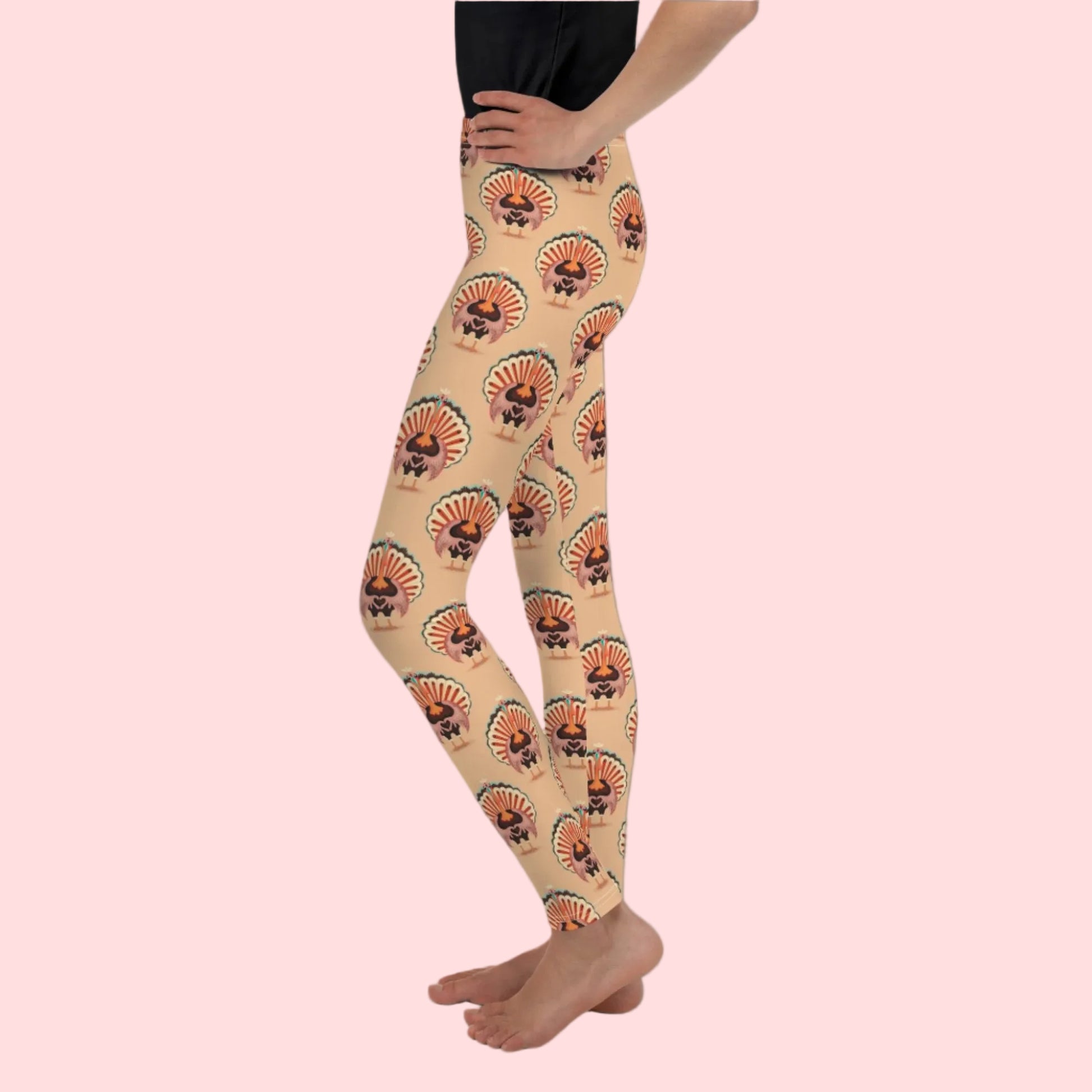 Thanksgiving Turkey Love child leggings. These girls yoga pants are peach, and have a repeating pattern of turkeys showing the love sign with their hands. These girls child tights make a great gift, or a family matching outfit for the Turkey Trot! by jaecrece
